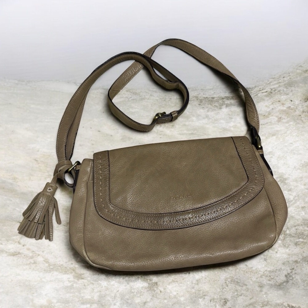 Picard leather crossbody bag in a taupe beige color front flap tassel detail